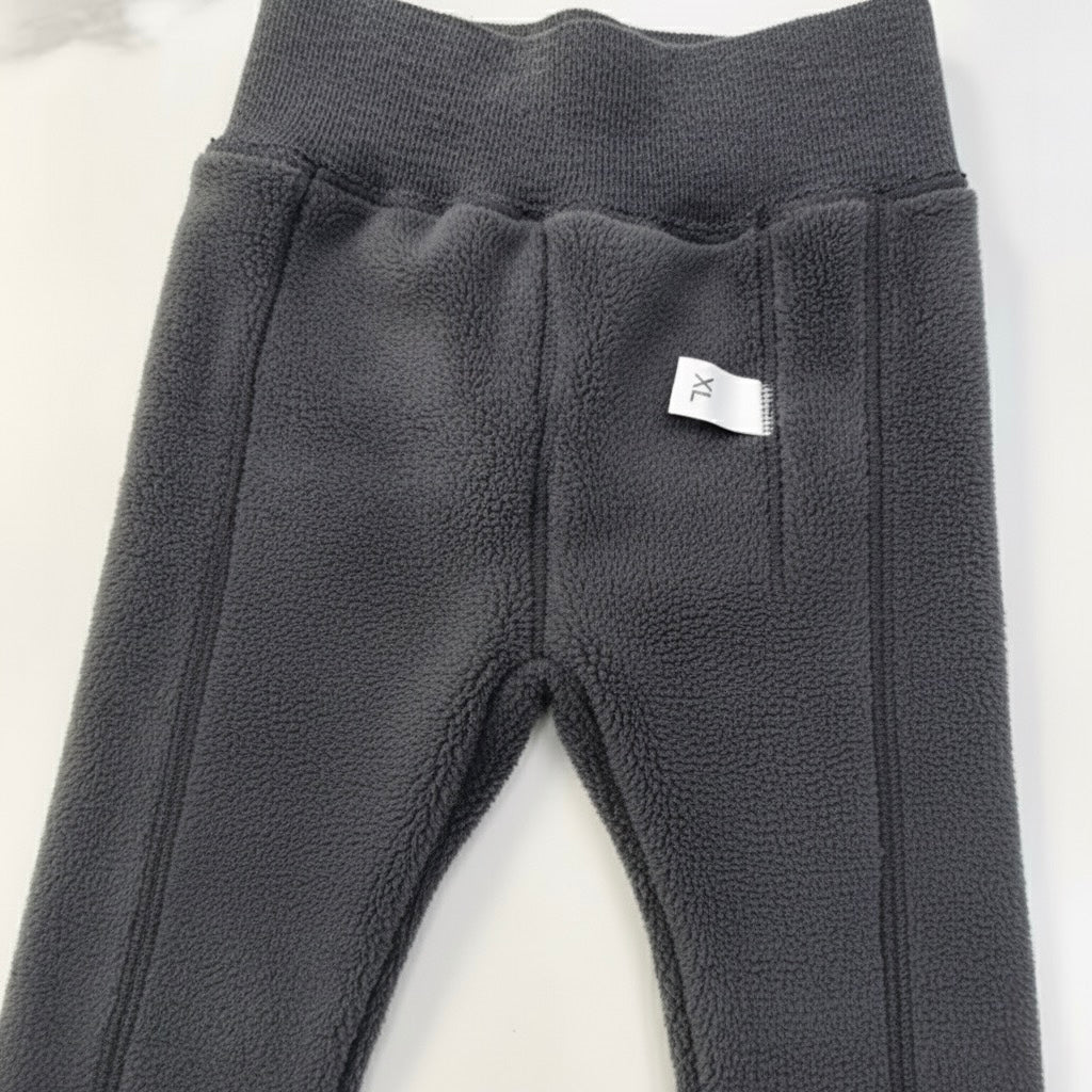 Dark gray fleece-lined ribbed footed leggings close-up, elastic waistband and bear patch