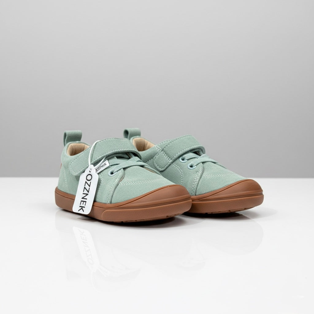 Kids mint-green canvas barefoot sneakers with brown rubber sole, side view