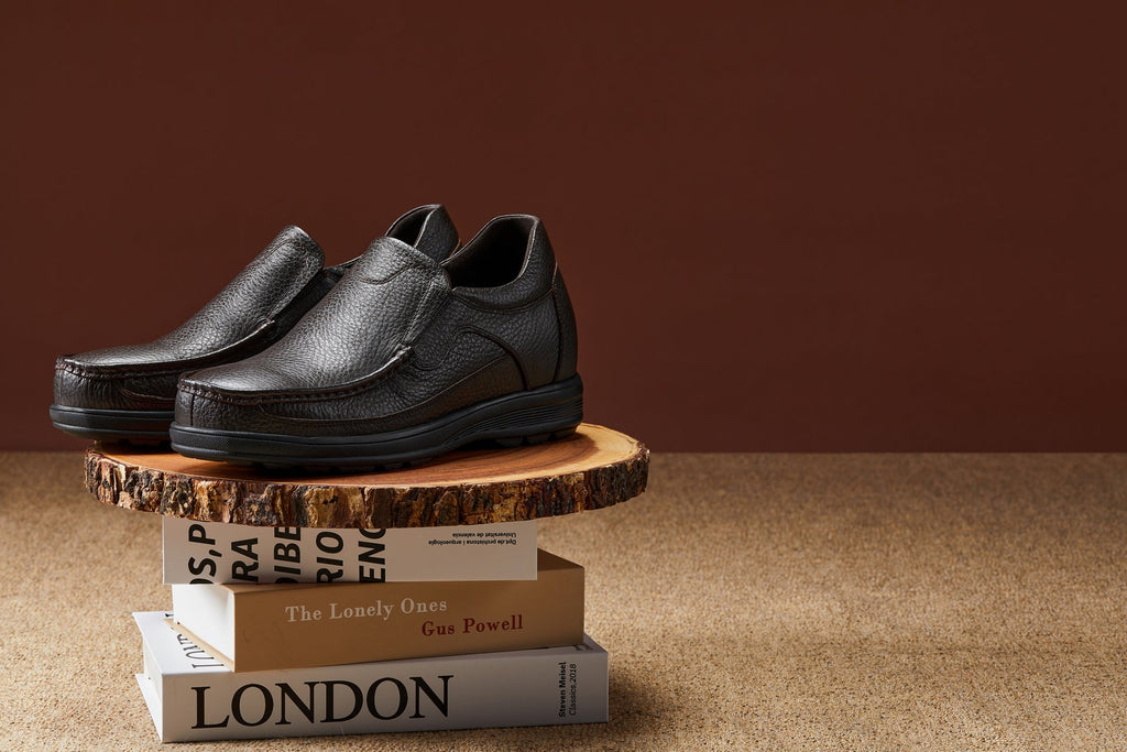 Dark brown leather slip-on loafer with rounded moc toe and treaded sole