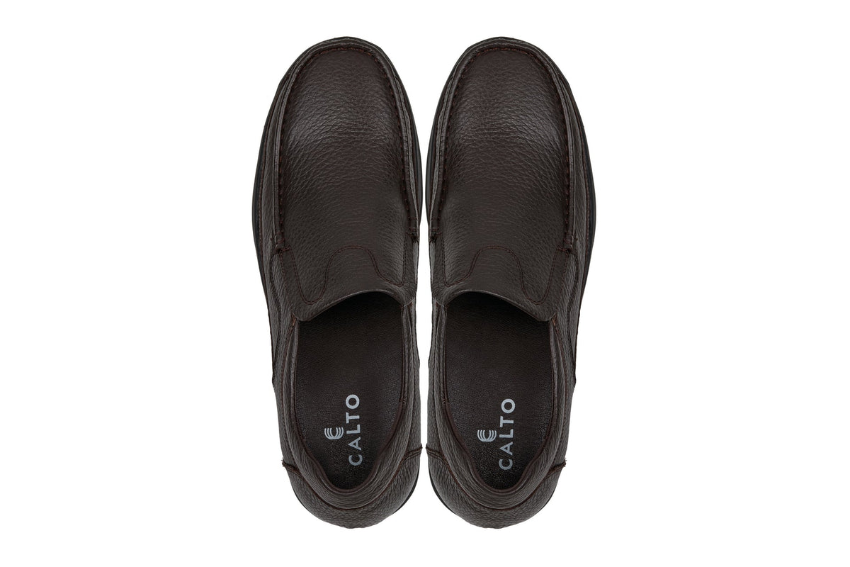 Pair of dark brown slip-on loafers with CALTO logo on the heel lining