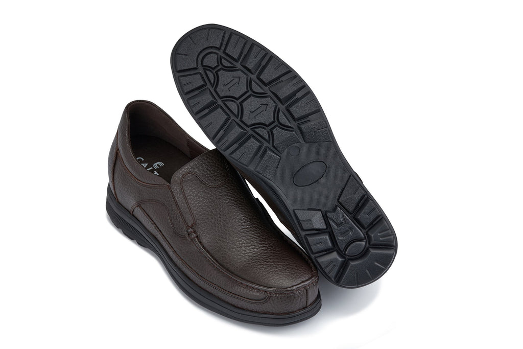 Dark brown slip-on loafer showing treaded rubber outsole and instep seam