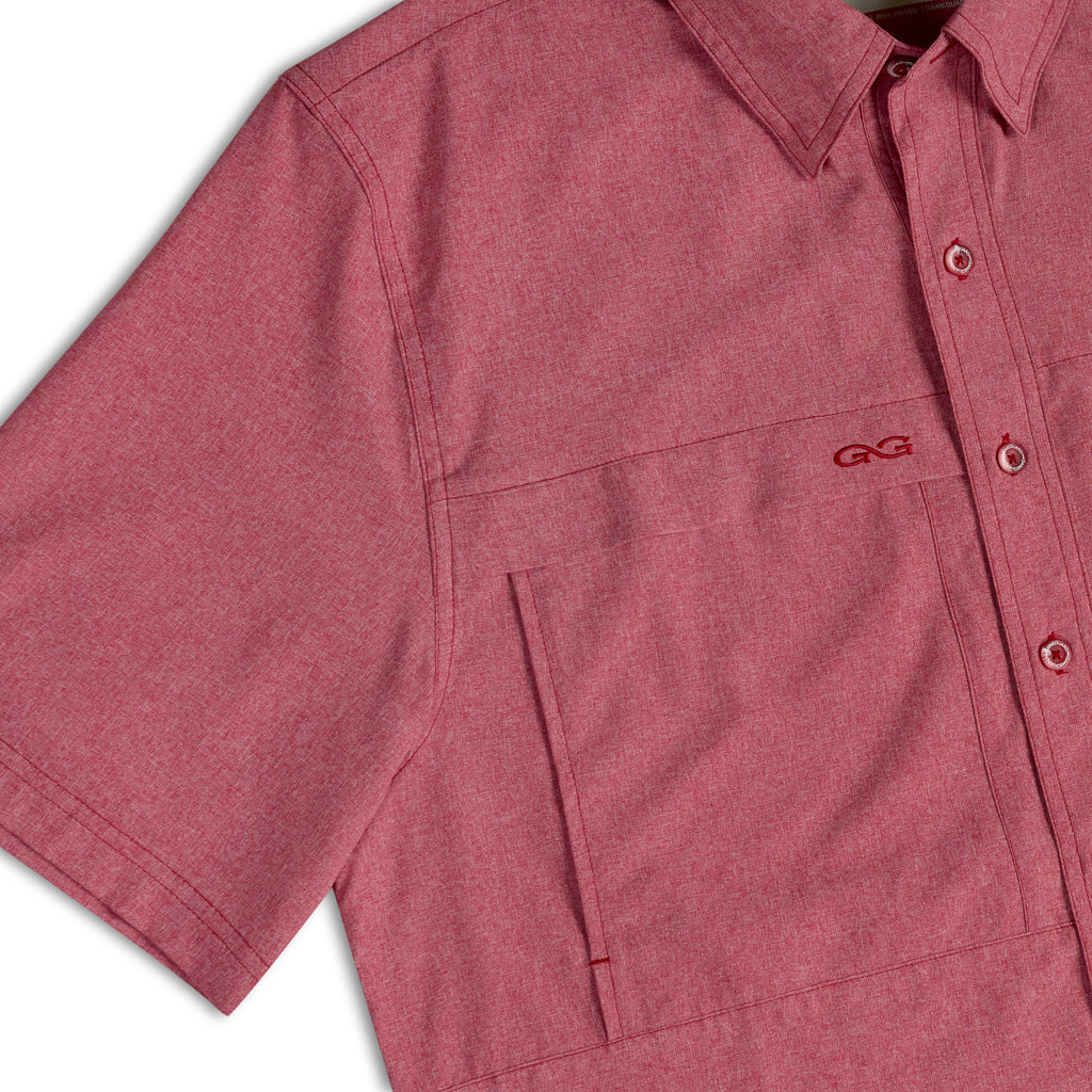 Crimson short-sleeve button-up shirt close-up of chest pocket, buttons, logo