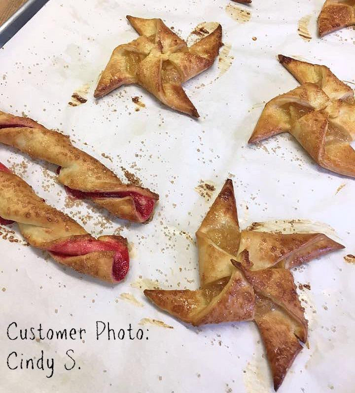 Gluten-free flour star-shaped pastries on parchment sheet with scattered crumbs