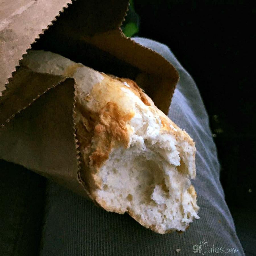 Gluten-free pizza crust half loaf with golden-brown crust and open crumb