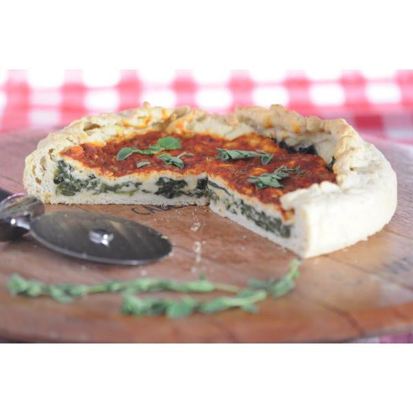 Gluten-free pizza crust slice with white cheese and green herb topping