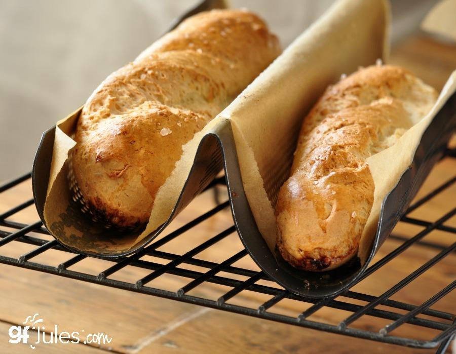 Gluten-free pizza crust rolls on a baking rack, golden and browned
