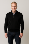 Black merino wool quarter-zip sweater with half-length zipper and ribbed cuffs.