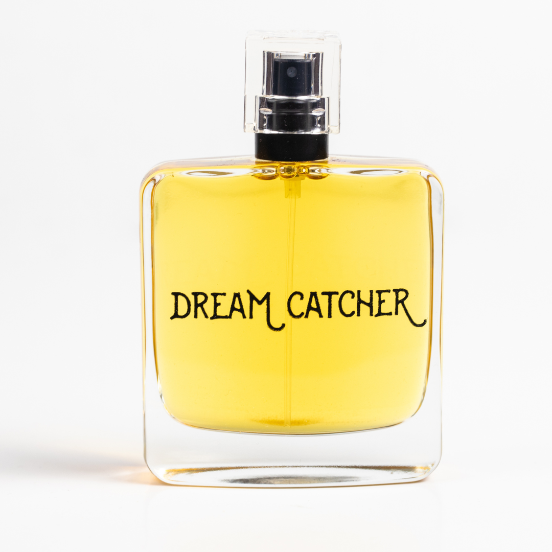 Dream Catcher botanical perfume bottle with clear glass, amber liquid, spray top