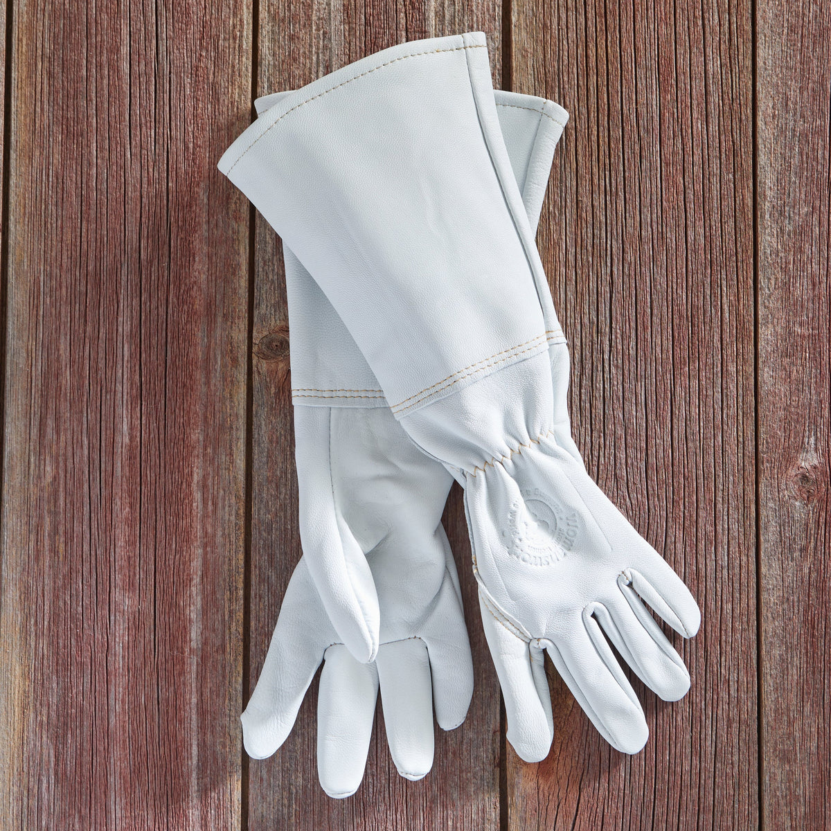 White goatskin gauntlet gloves with stitched cuff and fingertips, side view