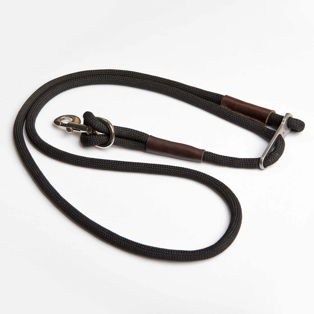 Dog leash with black rope-style webbing and brown grip sleeves, metal clasp