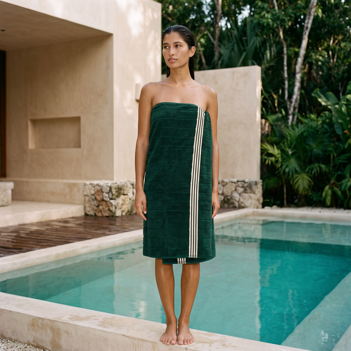 Green cotton towel with white stripe border wrapped around a model