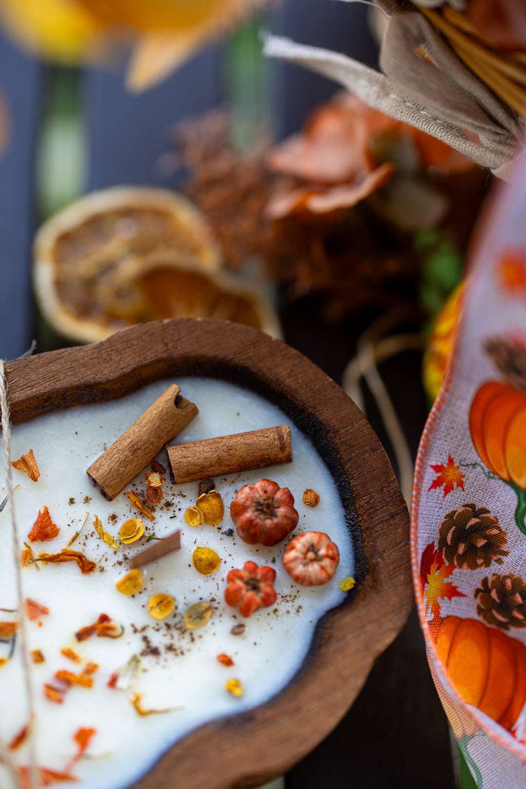 Wooden pumpkin dough bowl candle with white wax, spice sprinkles, and cinnamon stick pieces