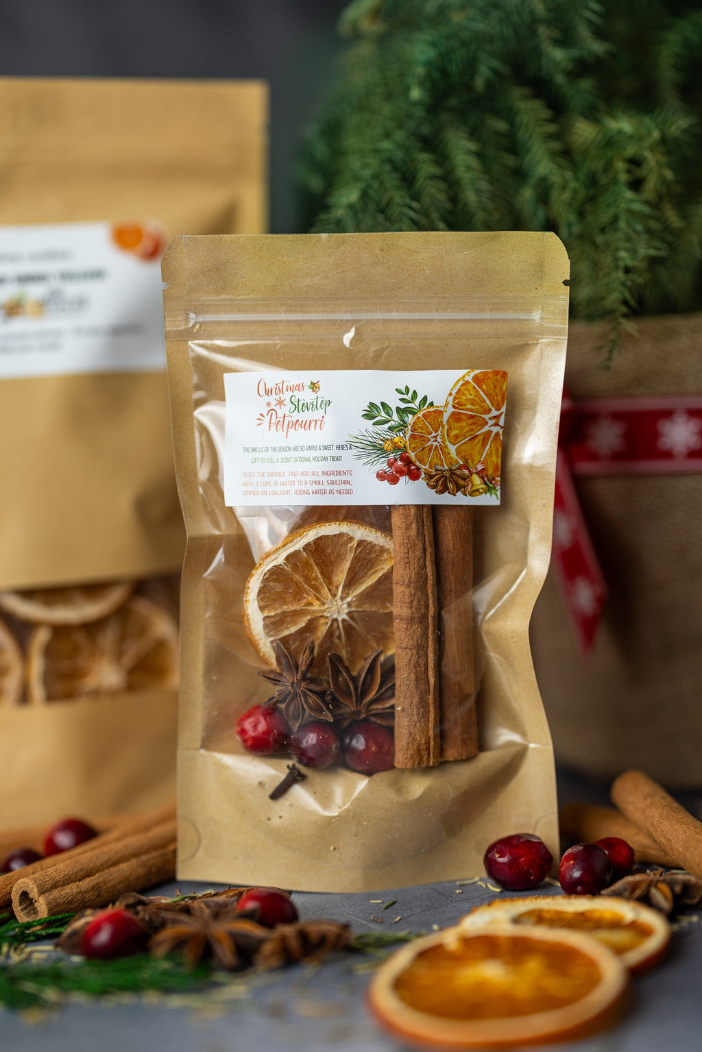 Stovetop potpourri mix pouch with dried orange slices, cinnamon sticks, and berries