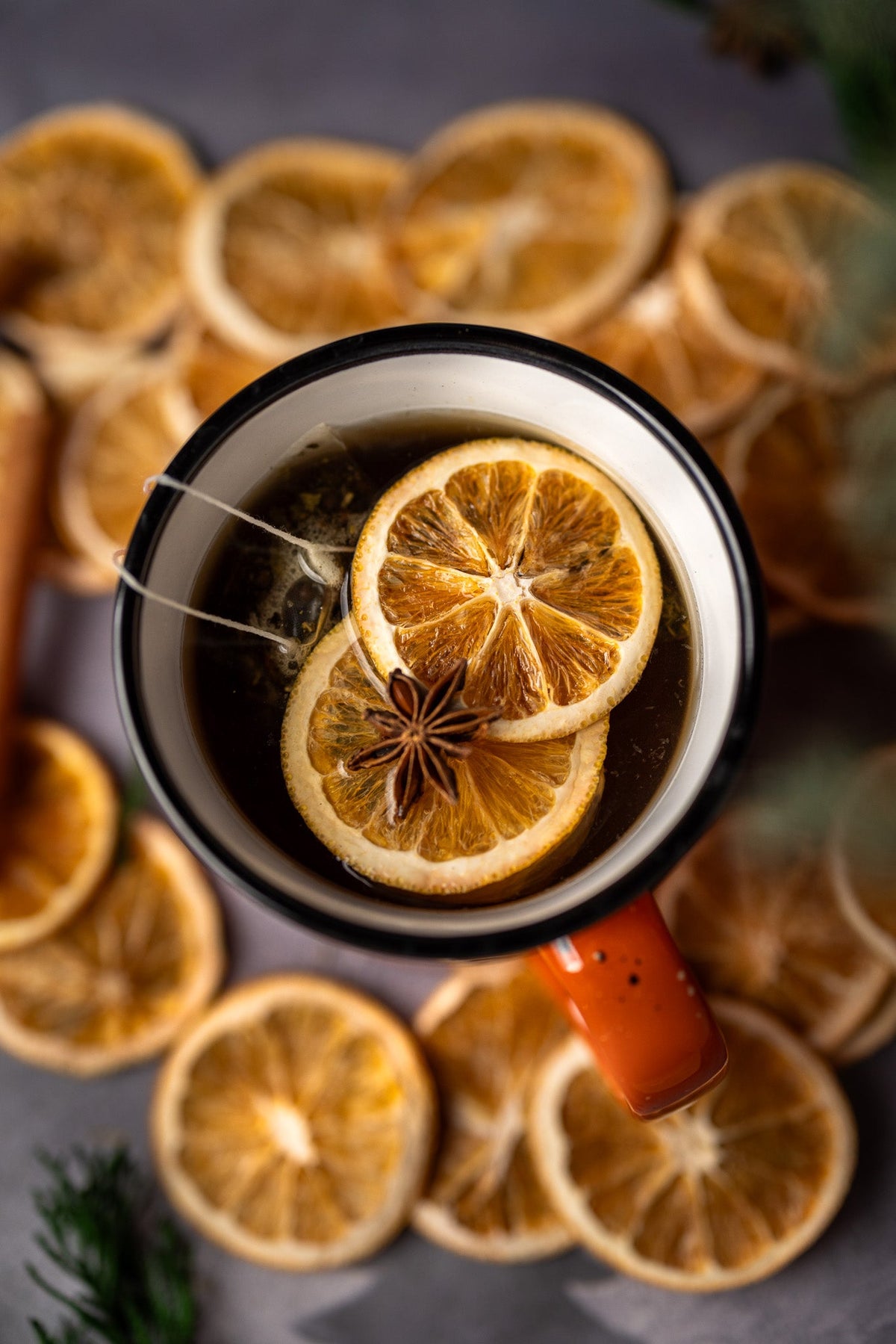 Spiced stovetop potpourri in mug with orange slice and star anise floating