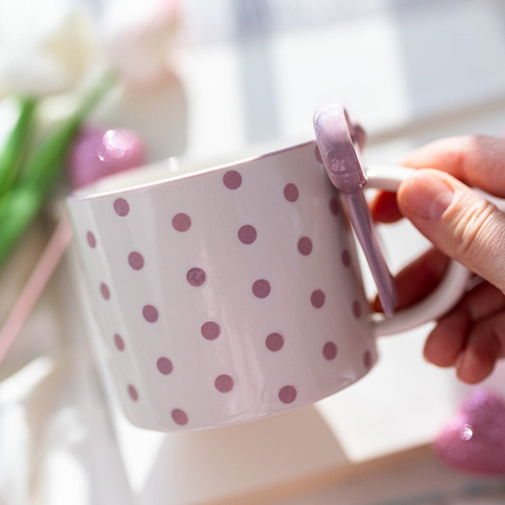 Ceramic mug in light pink with purple dot pattern and bowknot handle decoration