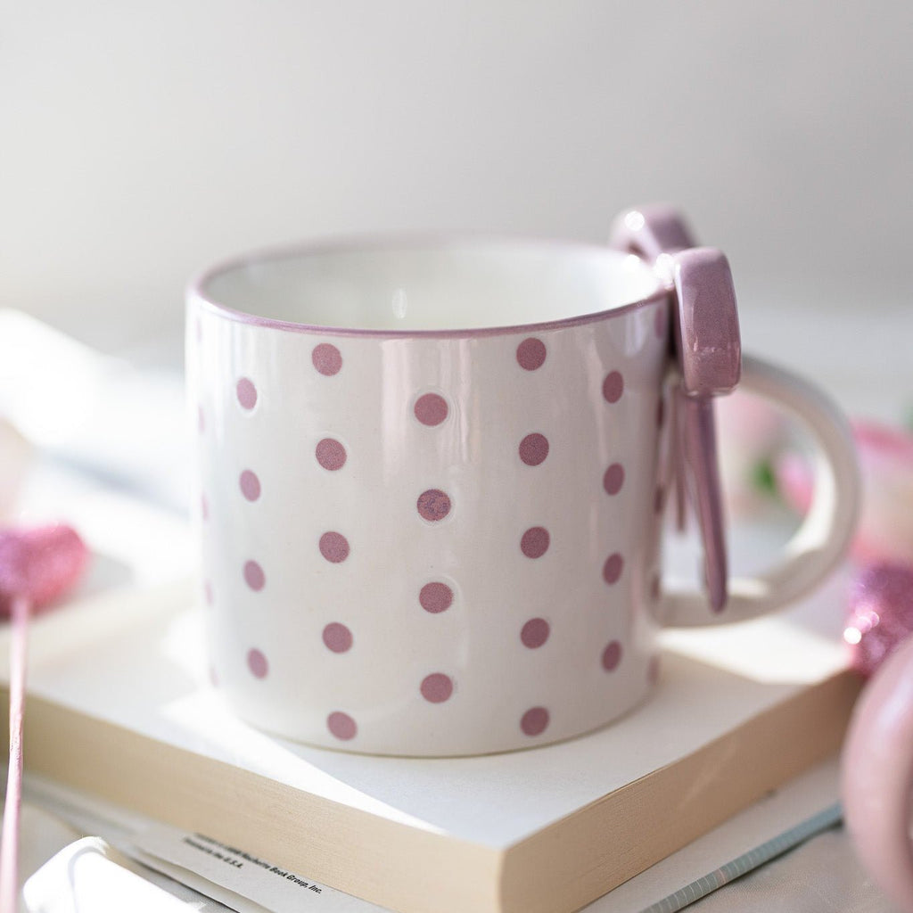White ceramic mug with pink polka dots and side bowknot bow detail