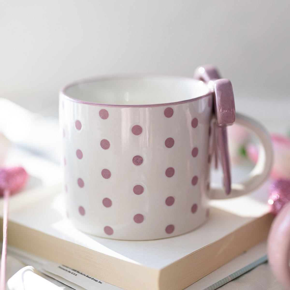 White ceramic mug with pink polka dots and side bowknot bow detail