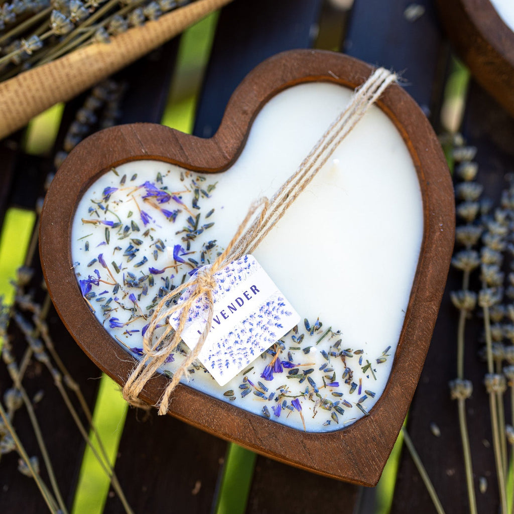 Heart-shaped wooden candle bowl with white soy wax, lavender sprigs, and bundled wick.