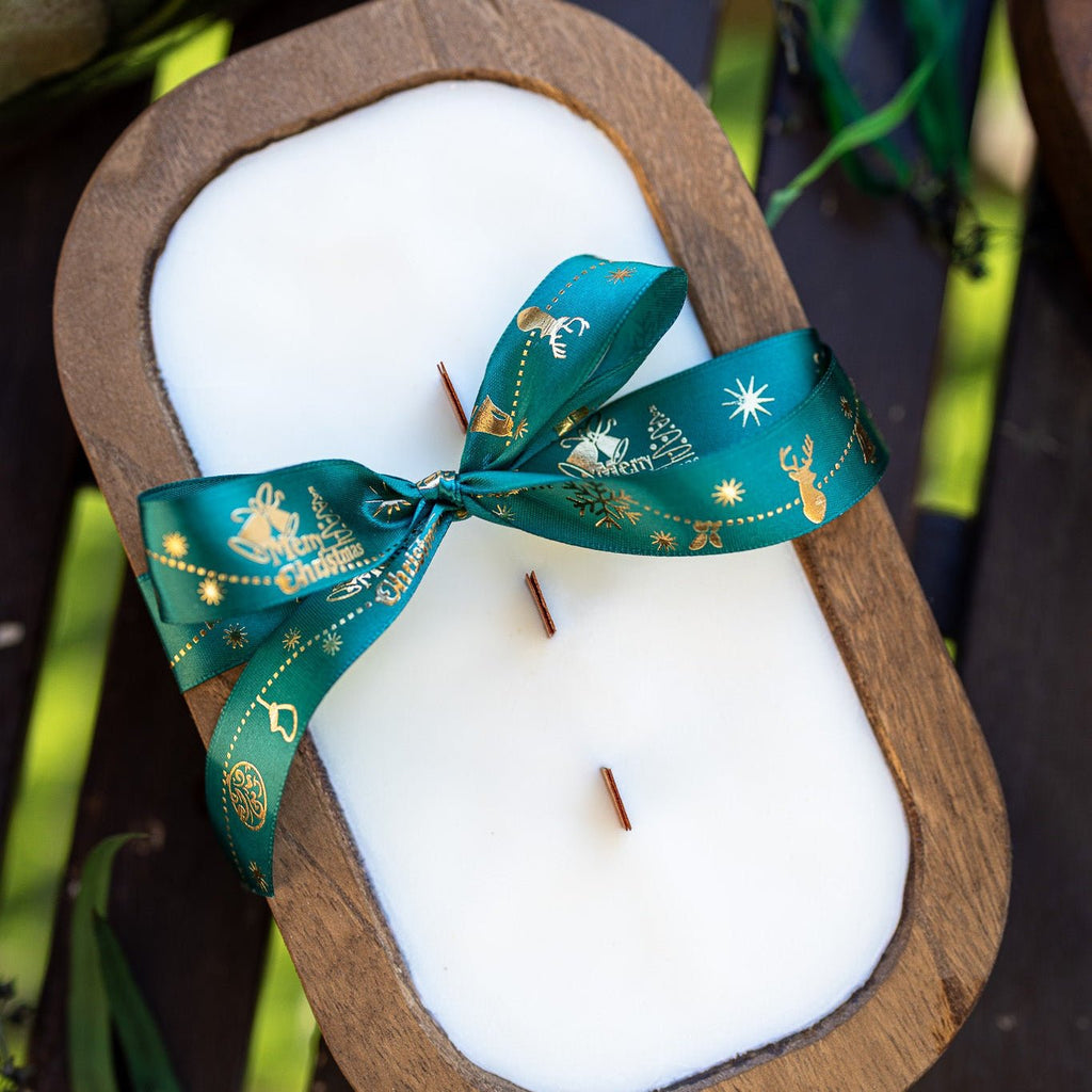 Wood dough bowl candle with white wax and teal holiday ribbon bow, exposed wicks