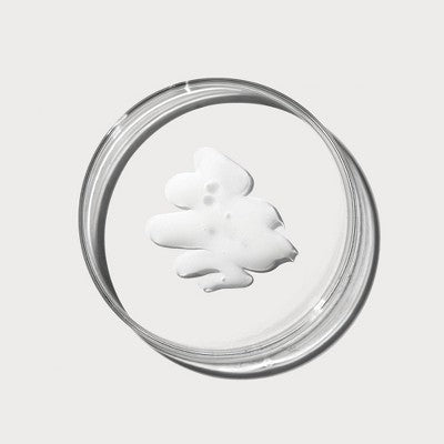 Thick cream swatch for retinol serum in a clear glass dish