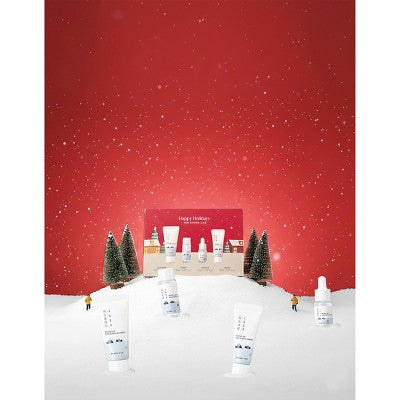 Holiday 4-piece travel skincare gift set with multiple mini bottles and tubes