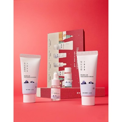 Travel skincare gift set contents with cleanser and cream tubes plus mini bottles