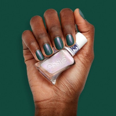 Hands wearing deep green and pearly lilac gel nail polish duo