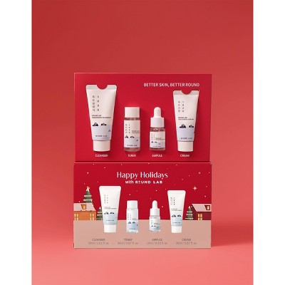 Holiday 4-piece travel skincare gift set with assorted miniature tubes and bottles