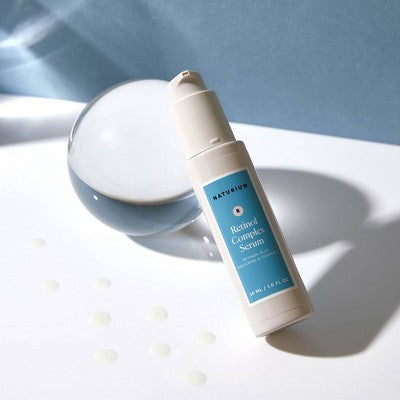 Naturium retinol complex serum bottle with pump, angled front view