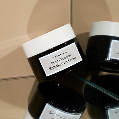 Naturium Plant Ceramide Rich Moisture Cream jar beside other skincare containers