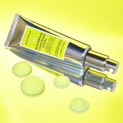 Naturium retinaldehyde cream serum tube with three green-yellow gel discs