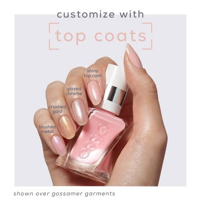 Hand holding gel nail polish bottles with pink base and metallic top coats