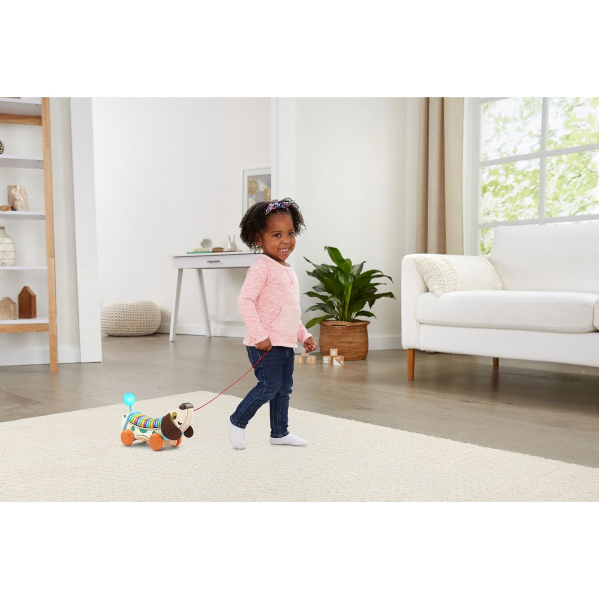 Wooden AlphaPup pull-along toy with rainbow ABC rollers and pull cord; toddler pulls