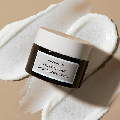 Naturium ceramide cream jar with cream swatch on skin-like surface