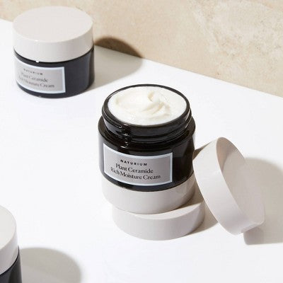 Naturium ceramide cream jars with white cream swirls on display