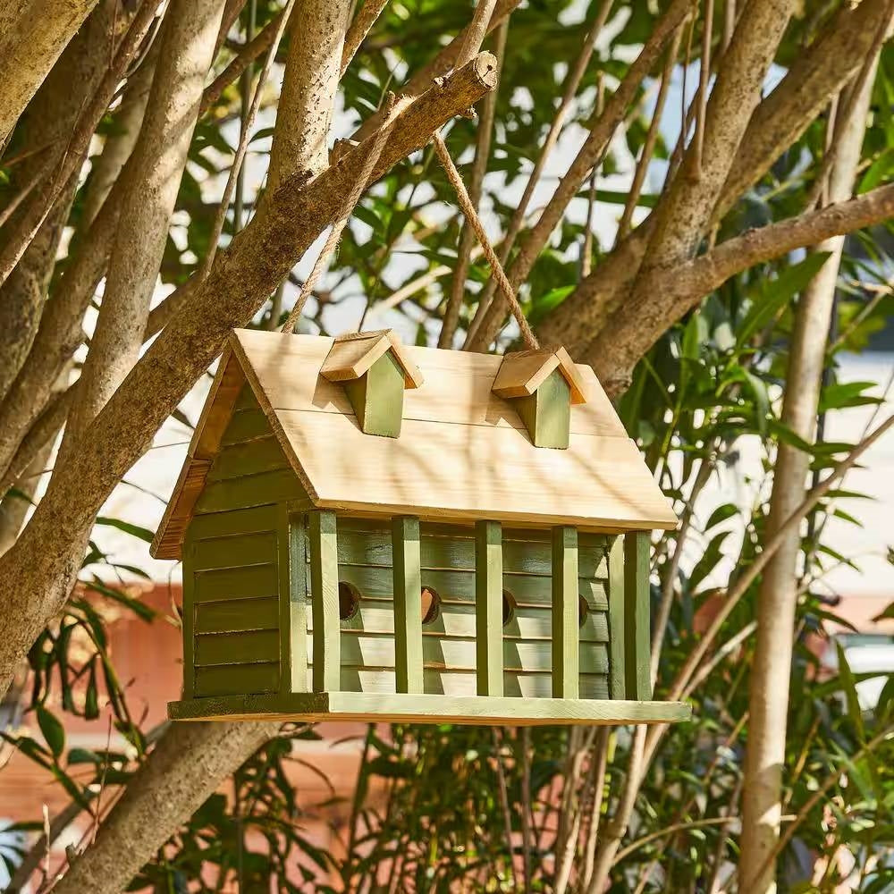 Green wood hanging bird house with four round entrance holes on the front