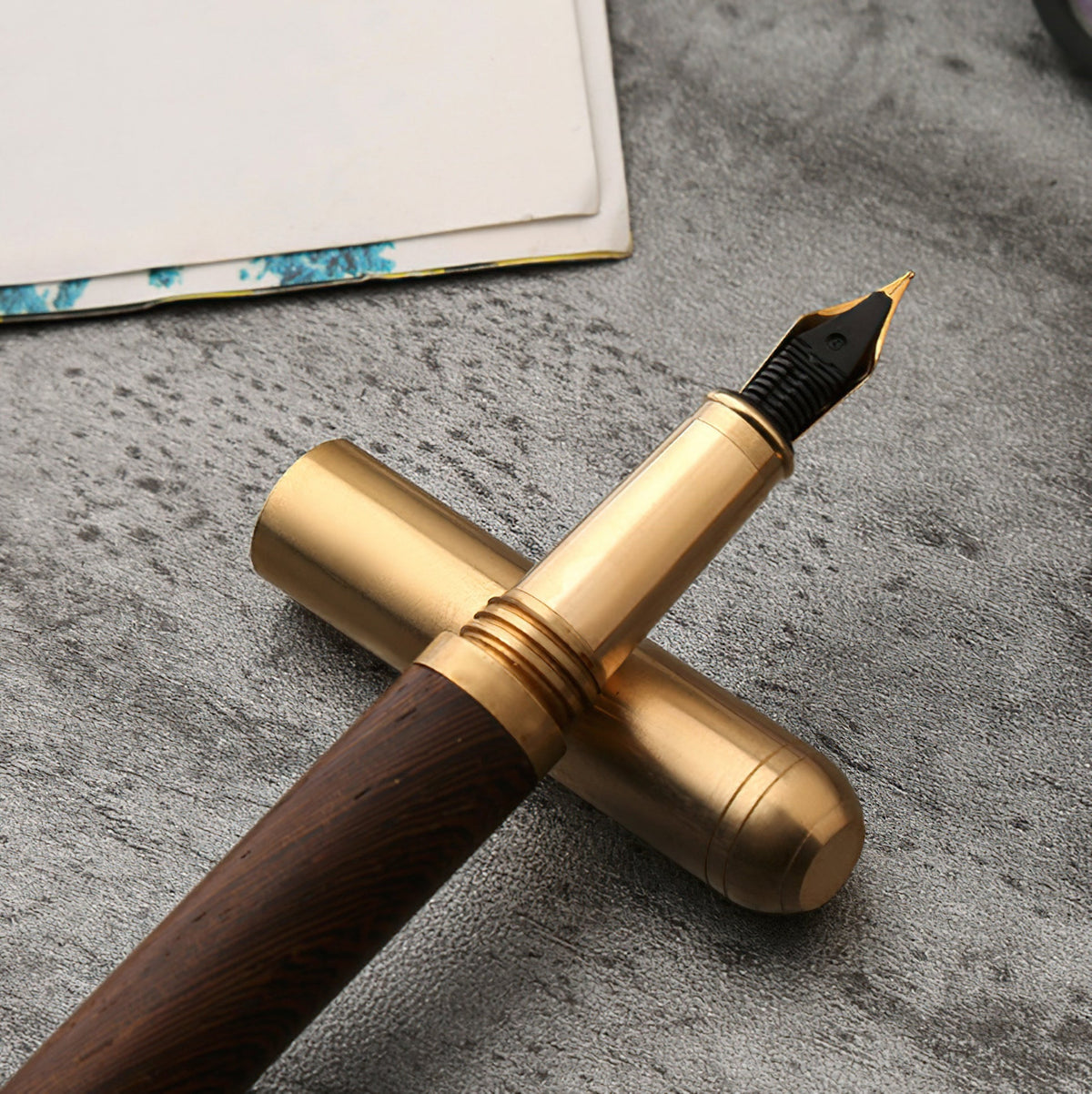 Handmade fountain pen with gold cap and black-tipped nib