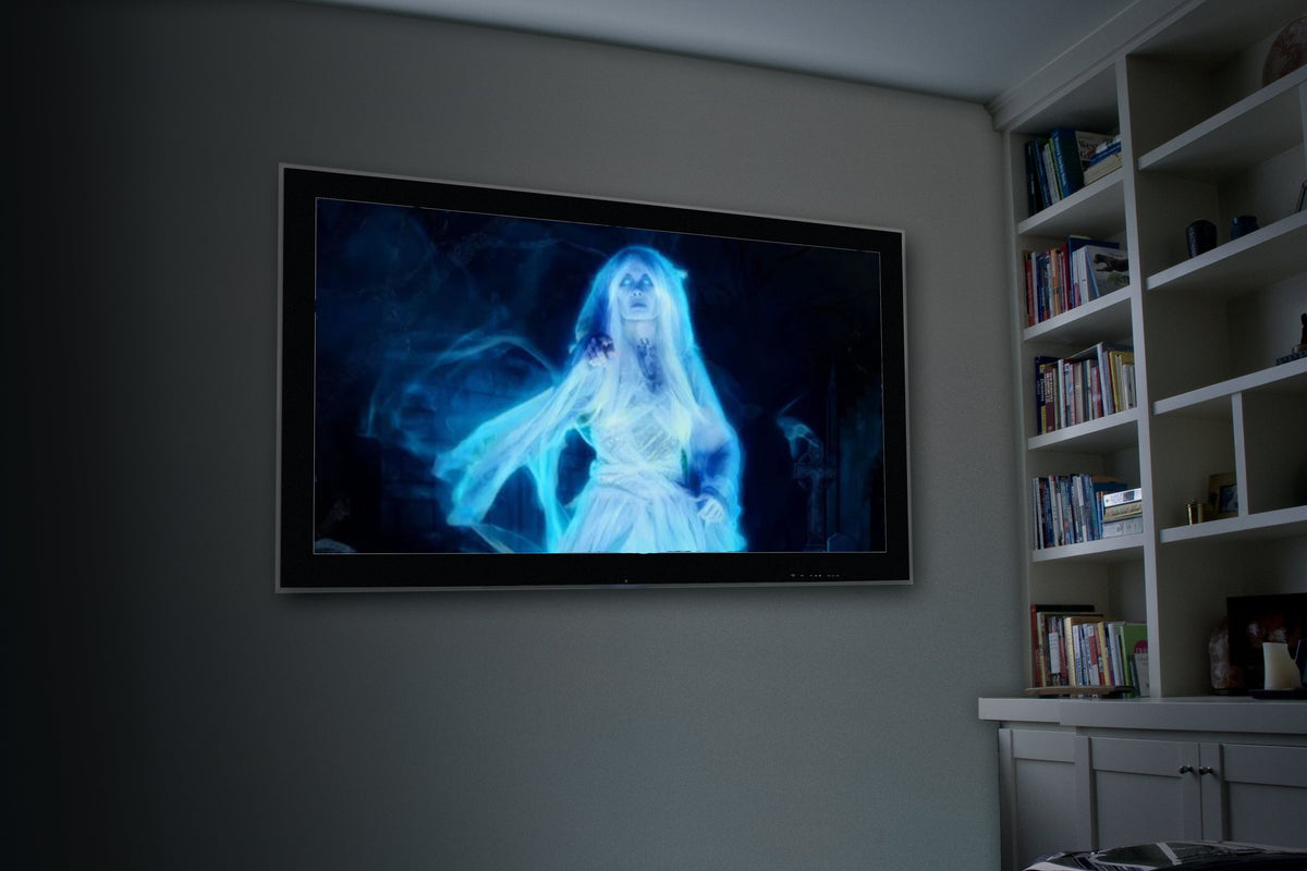 Wall-mounted Halloween projection of ghost figure in blue light in a living room