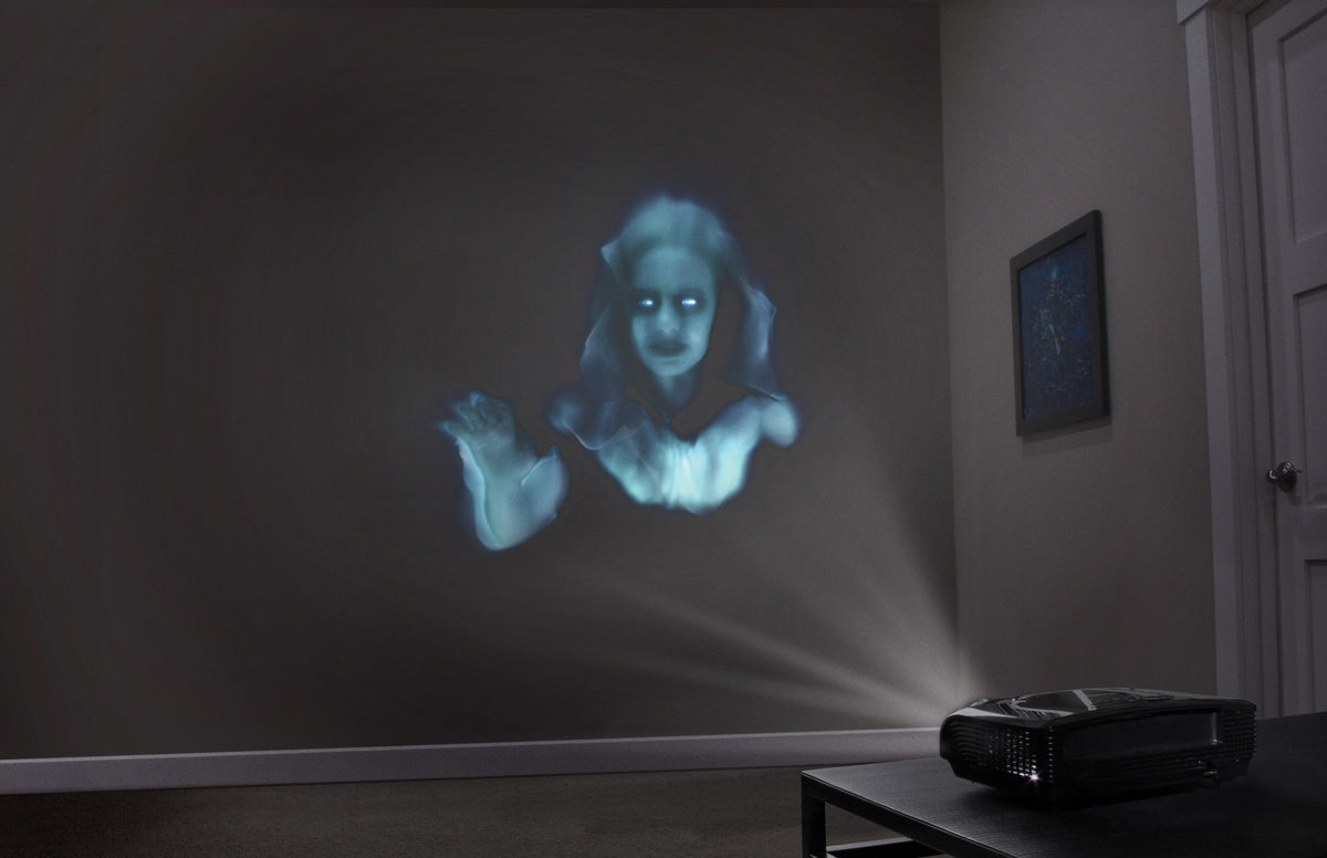 Halloween ghost projection face on wall with projector device on floor