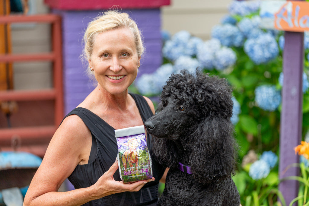 Bath salt bag held in hand, showing purple label with goat graphic