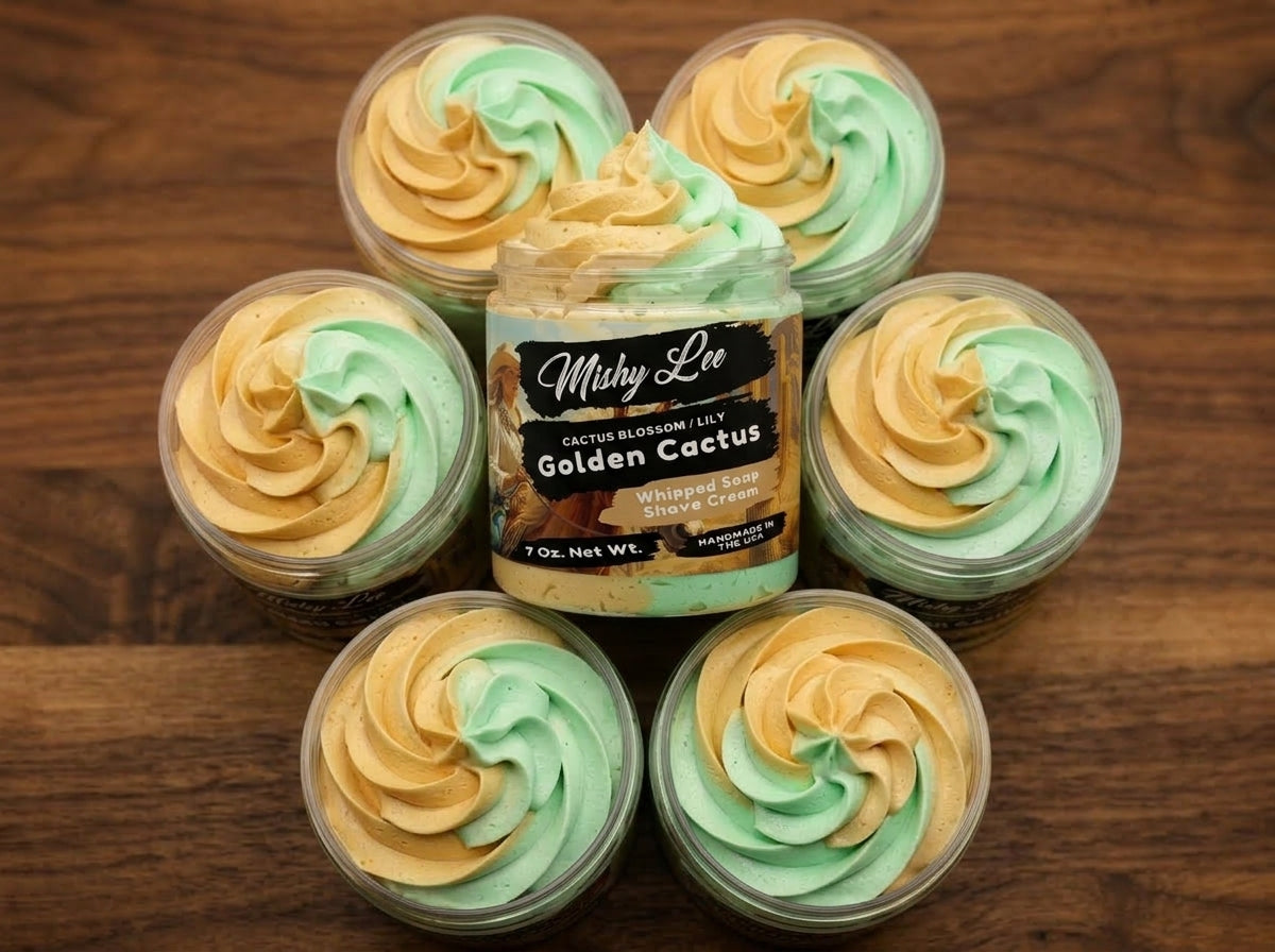 Whipped soap and shave cream cups with gold and green swirl tops in a group
