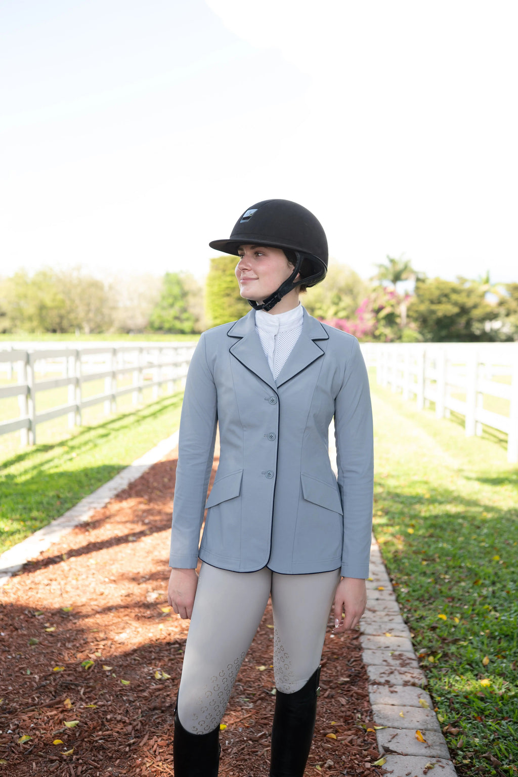 Ladies show coat with navy piping on lapels and pockets, cadet-blue fabric and three buttons