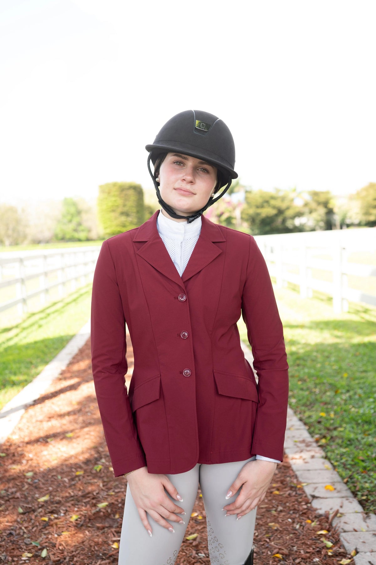 Burgundy ladies show coat with three-button front and notched lapels