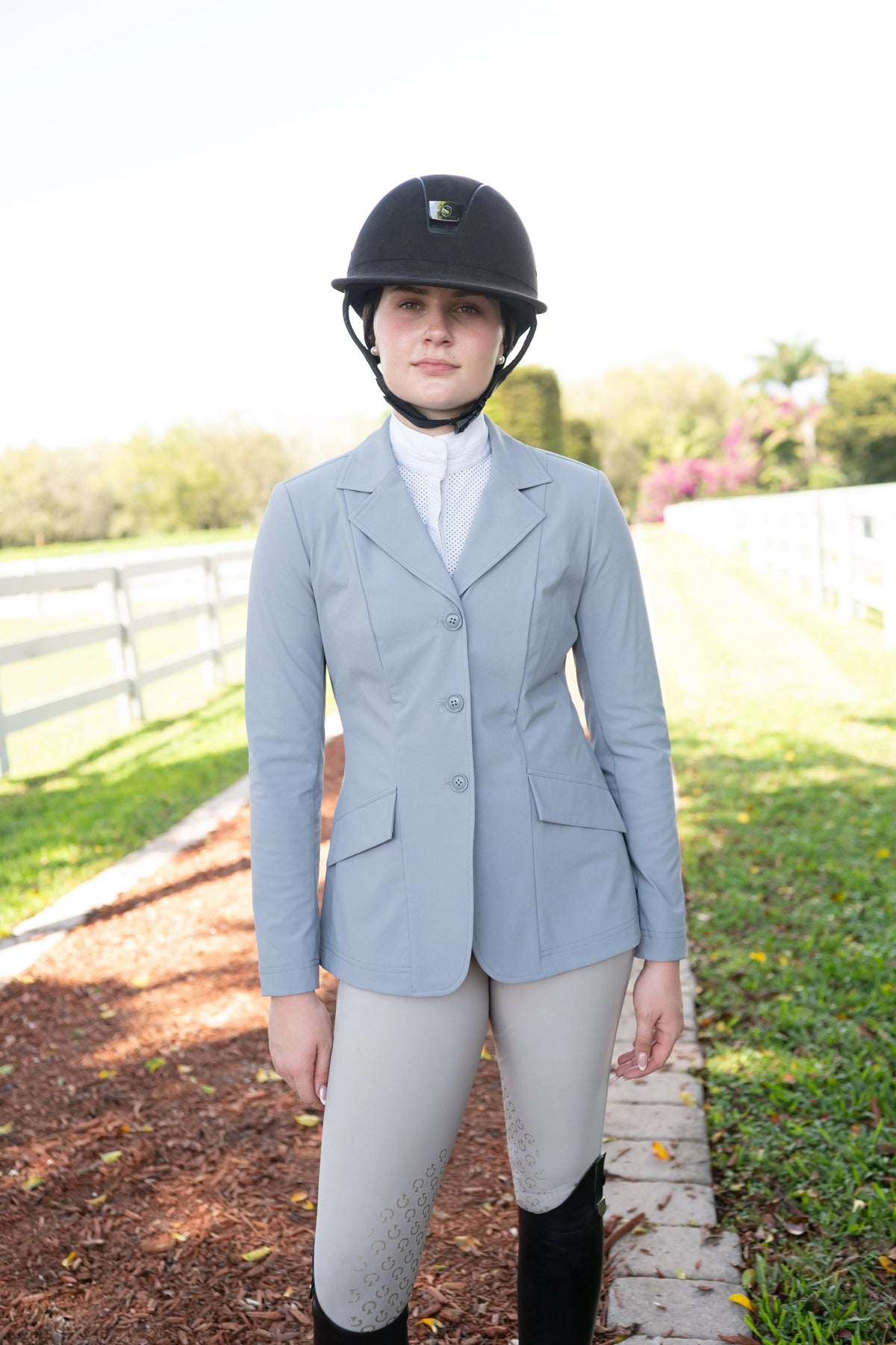 Cadet blue ladies show coat with notched lapels, three-button front, flap pockets, long sleeves