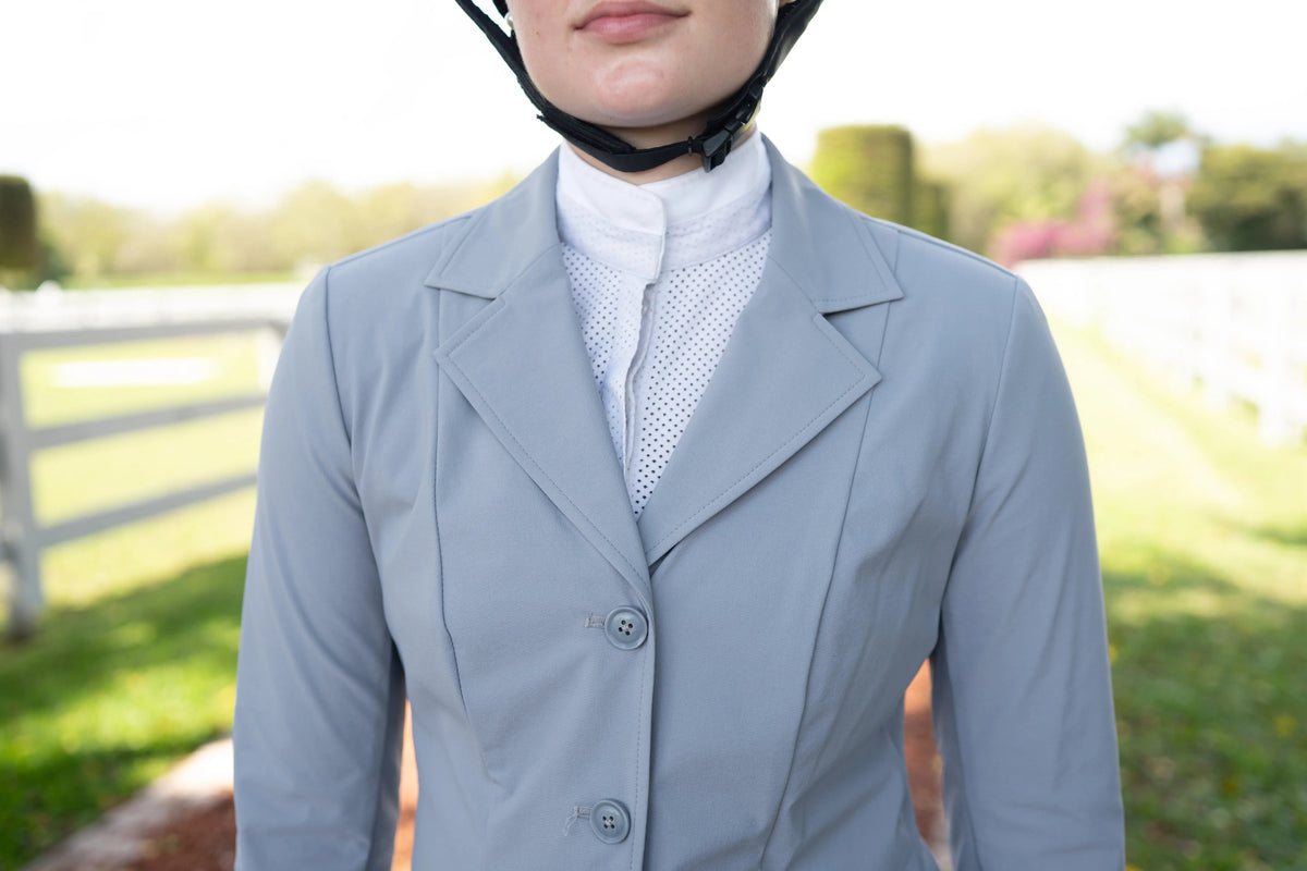 Close-up of cadet blue ladies show coat with three-button front and notched lapels