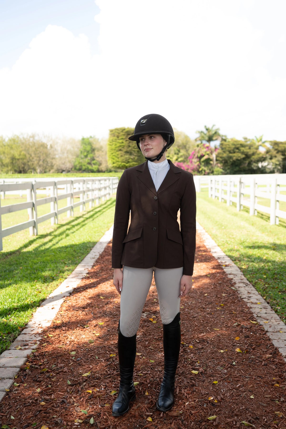 Women’s chocolate-brown show coat with long sleeves, buttons, and flap pockets