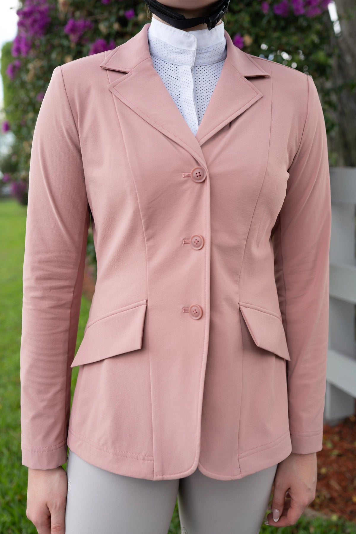 Rose pink show coat close-up with notch lapels and three-button placket