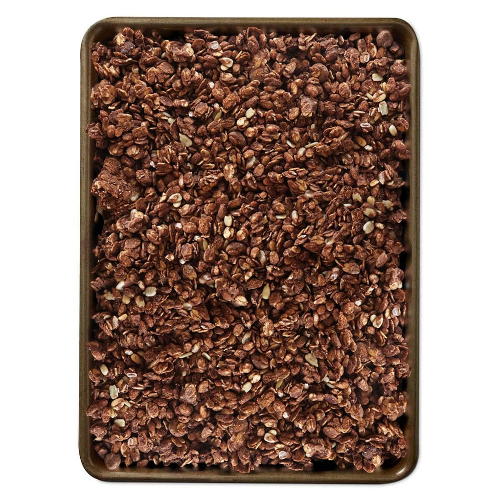 Dark chocolate sea salt granola in a square tray, textured oat clusters