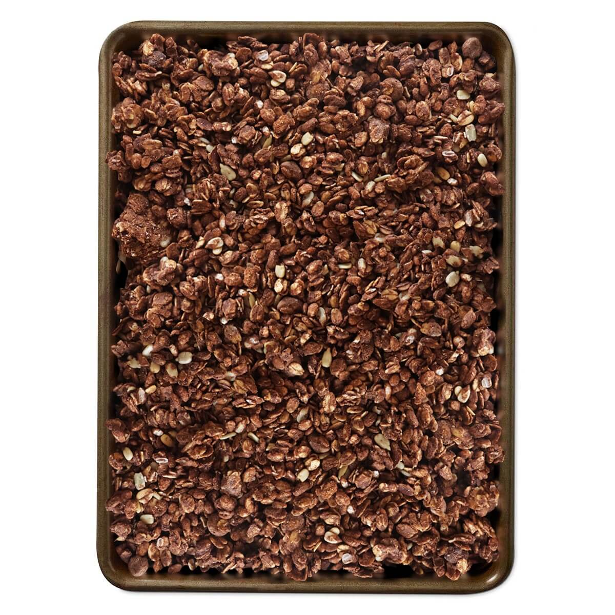 Dark chocolate sea salt granola in a square tray, textured oat clusters