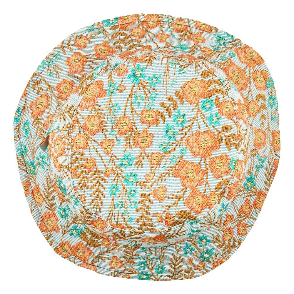Reversible bucket hat floral back view, orange and teal foliage pattern